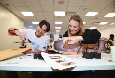 Two FOX employees putting together skateboards.